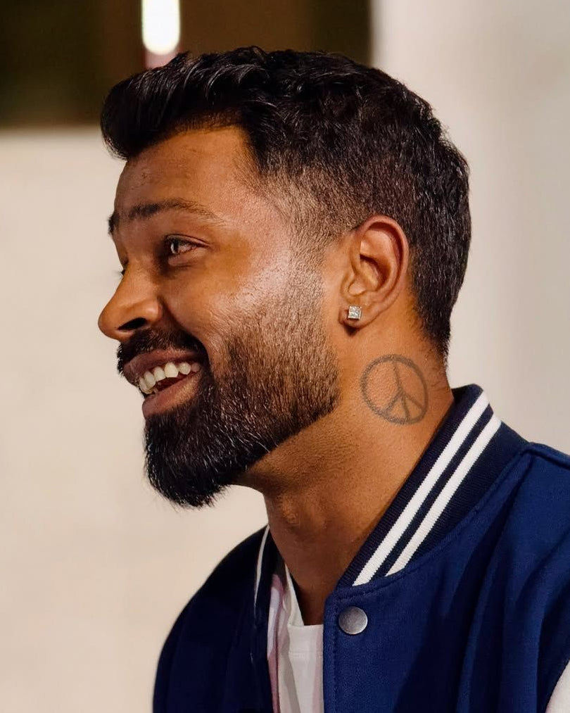 Man wearing a blue and white varsity jacket with a blurred background