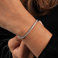 Silver bracelet on a wrist with a blurred background